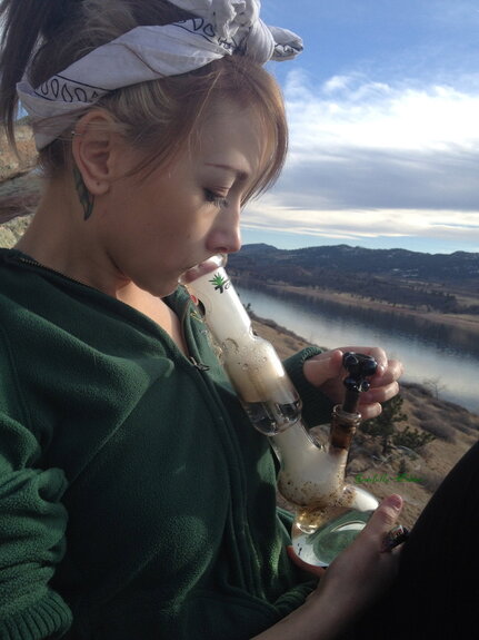 blonde girl smoking bong outside
