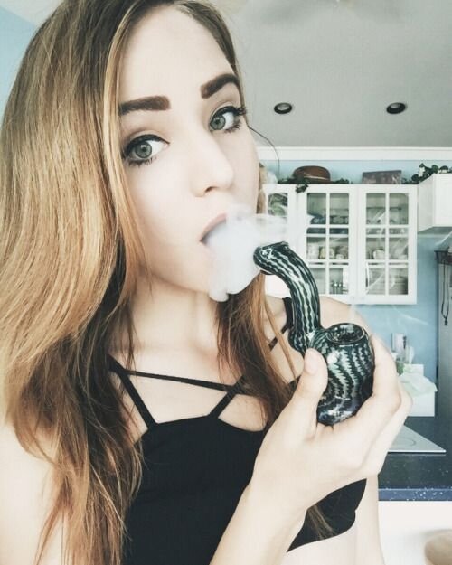 brunette girl smoking weed pipe