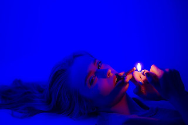 pretty girl in blue smoking weed