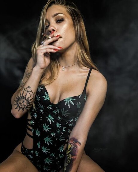 sexy tattooed girl smoking joint
