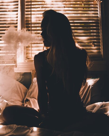 silhouette of girl smoking weed